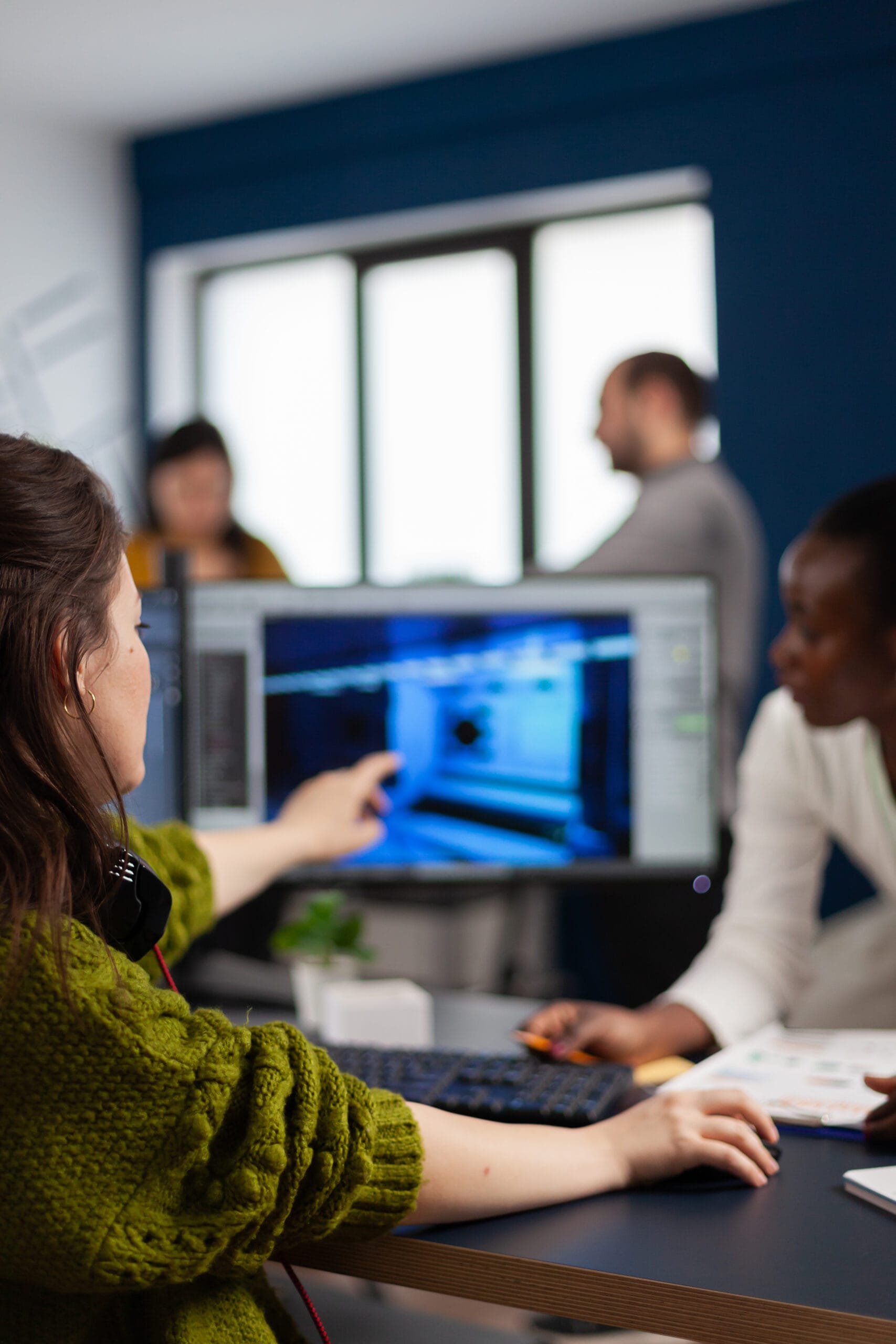 Gamer creator explaning to african worker how develop game level interface | Bpointer Website Development Cost in India
